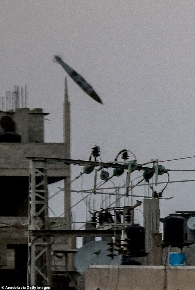 An Israeli missile is captured just before it hits the Bureij camp in Deir al Balah