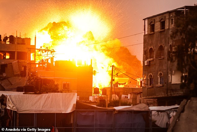 Flames destroy a building in Al Bureij camp in Deir al-Balah