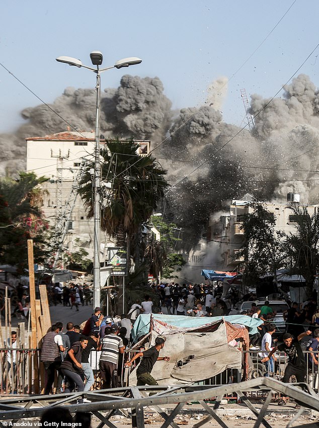 Smoke rises from the Al-Magahazi building being bombed during the Israeli attacks on the Al Bureij camp