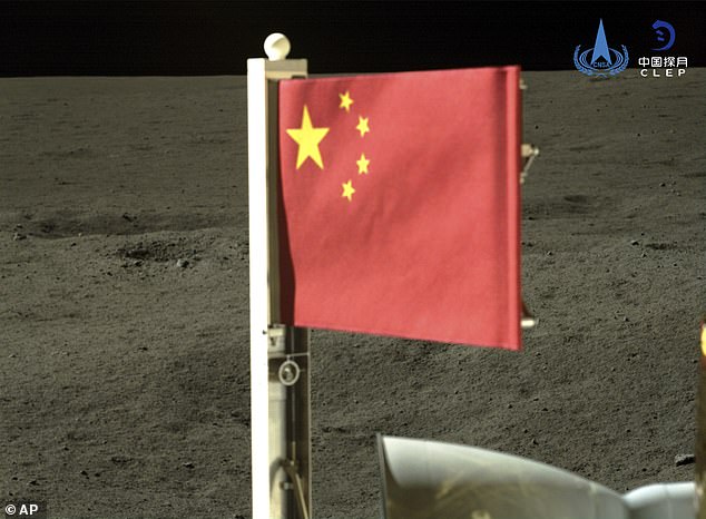 A Chinese lunar rover has raised the first national flag on the dark side of the moon before returning to Earth with samples of lunar material