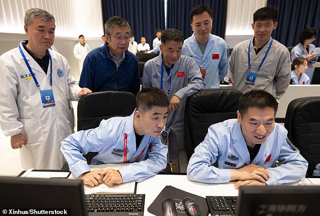 The lander was operated from a control center in Beijing (pictured), but the signal had to be bounced back by a relay satellite launched in May to reach the far side of the moon.