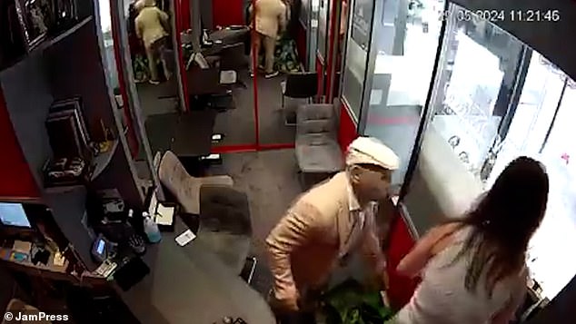 The masked robber forces the woman to take the watches during the seven and a half minute robbery