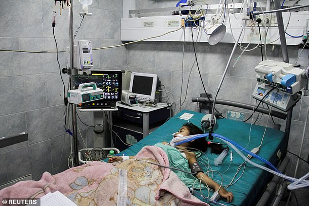 A Palestinian child suffering from malnutrition receives health care at Kamal Adwan Hospital in northern Gaza Strip