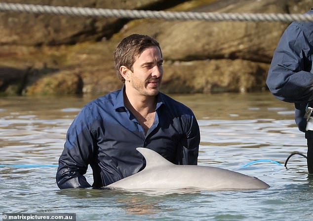 Despite the harsh conditions, Ryan seemed completely at ease in the water as he stood next to his acting buddy