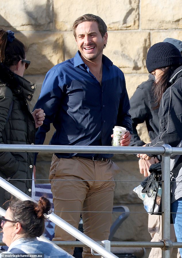 He laughed and chatted with crew members while waiting for someone to bring him a jacket