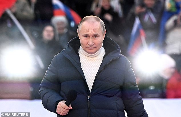 Russian President Vladimir Putin delivers a speech during a concert marking the anniversary of Russia's annexation of Crimea at Luzhniki Stadium in Moscow.  He is said to have regularly worn bulletproof vests at public events