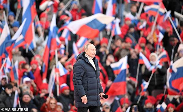 FILE PHOTO: Russian President Vladimir Putin delivers a speech during a concert marking the eighth anniversary of Russia's annexation of Crimea at the Luzhniki Stadium in Moscow, Russia, March 18, 2022