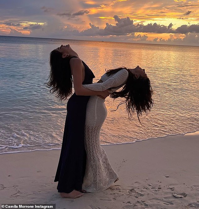 The besties enjoy a laugh together during a breathtaking sunset in the Caribbean