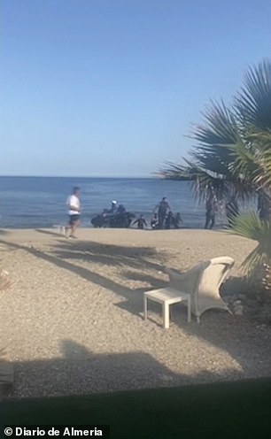 A bewildered jogger could be seen running past the boat as it landed on the sandy stretch of coastline in southern Spain