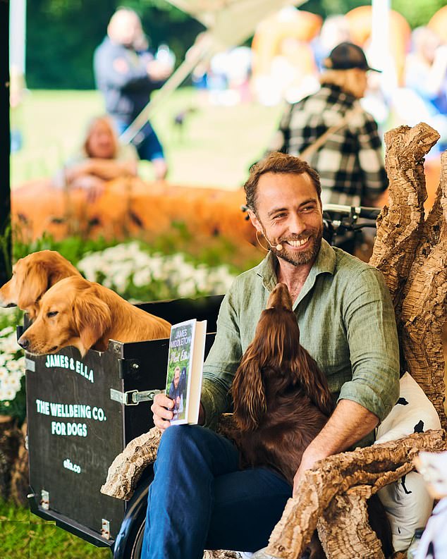 Photos from the event show him beaming as he is joined by his other puppies who sat in his personalized Babboe bike as he held up the new cover