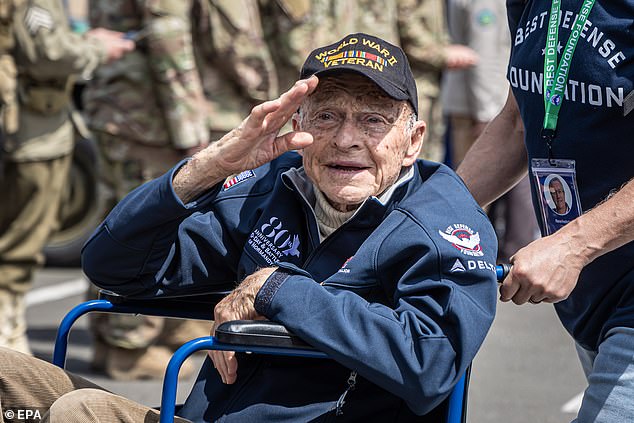 Veteran Andre Chappaz greets the crowd as he arrives at the solemn tribute