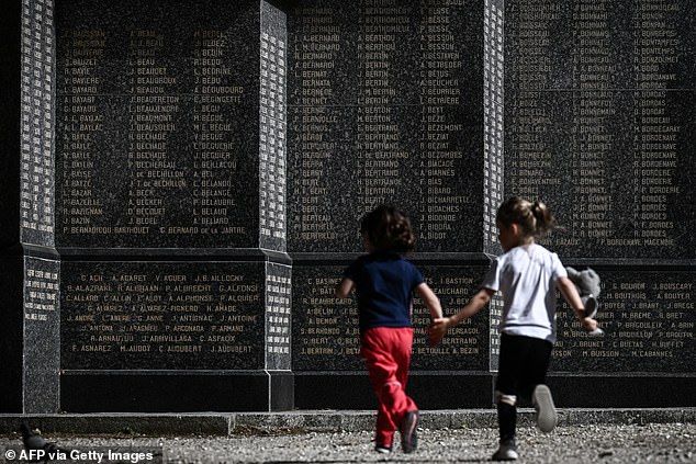 Footage from the event showed children playing around a memorial to the tens of thousands who lost their lives on D-Day, while veterans said they 'probably wouldn't be here if we hadn't been successful'