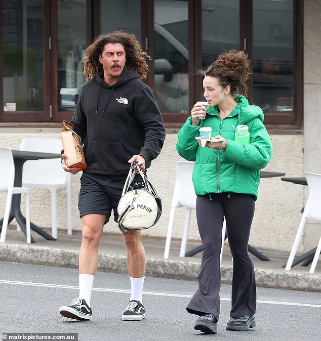 He completed his look with a pair of Vans sneakers and carried his $198 Fred Perry duffel bag