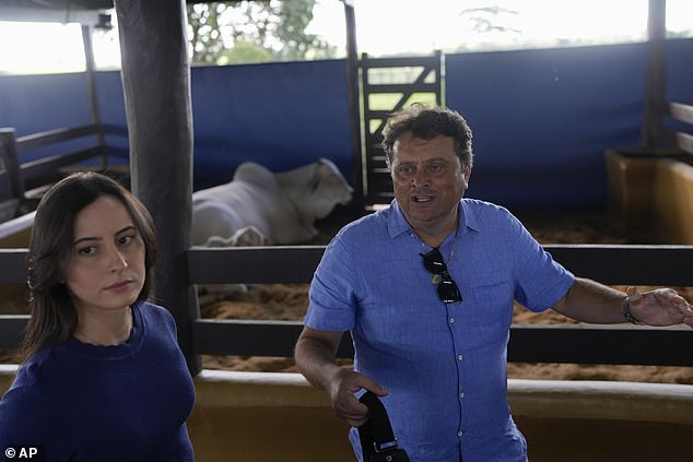 Ney Pereira and his daughter, veterinarian Lorrany Martins, give an interview in a stable on his farm in Uberaba, Minas Gerais state, Brazil