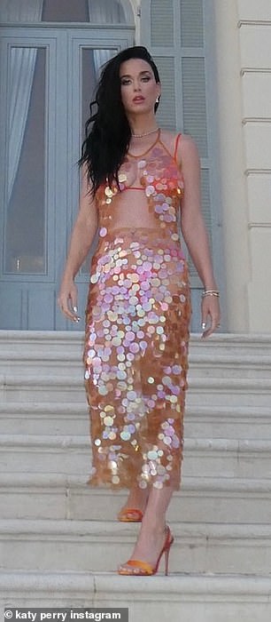 She also donned a sheer sequined blouse, which exposed her toned midriff, and the matching midi skirt over her swimsuit for close-up photos outside the hotel.