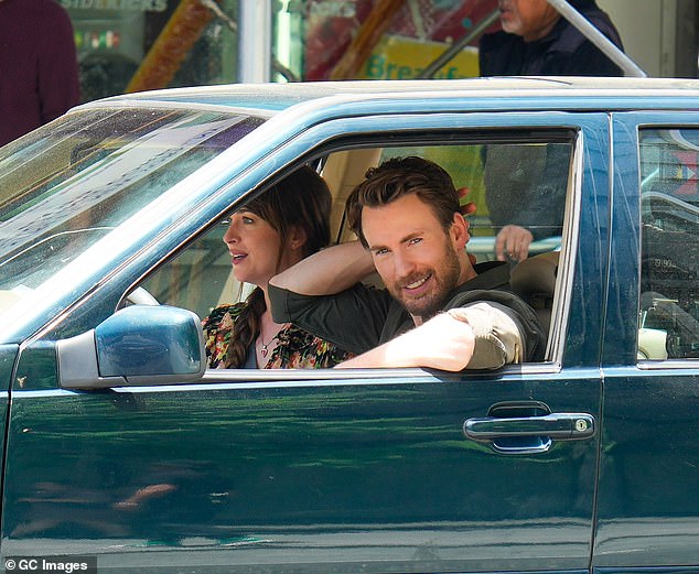 Rolling down the window, Chris smiled into the camera as the pair sat in the front seats filming their rom-com