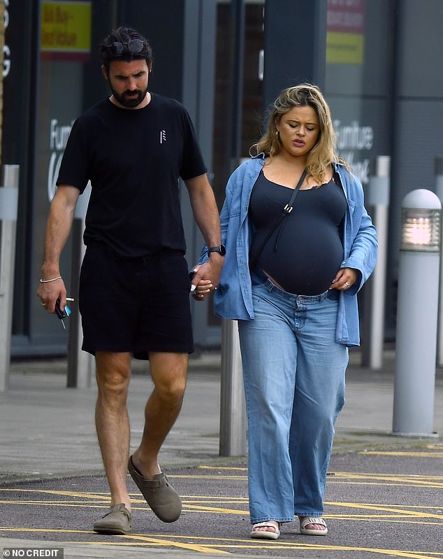 The loved-up couple lovingly held hands during their outing before welcoming their newborn