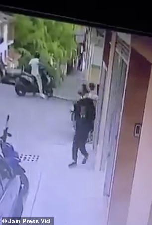 The masked gunman is seen leaving the store