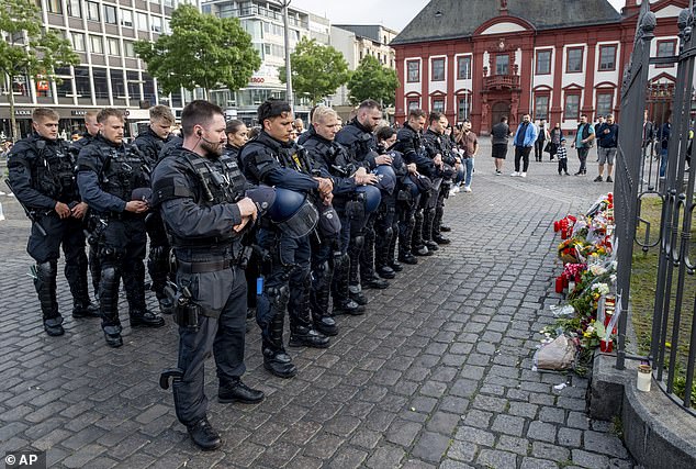 German police officers pay respects to their colleague who died after a stabbing