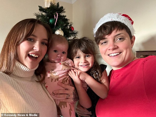 Isabella's mother Adele Telford (left), 31, said as soon as she heard Isabella had swallowed the battery, she and her wife Emily (right) had to rush her to hospital.  The couple are pictured here with Isabella and one of their other children, eight-month-old Everley