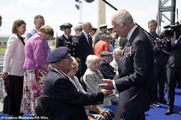 King Charles greets Eric Bateman after giving his emotional speech in Portsmouth today