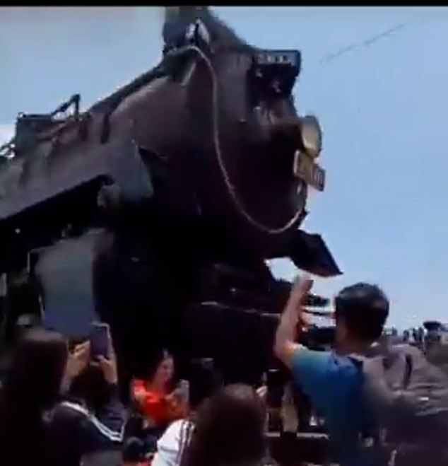 Video shows a huge train looming over the woman just before hitting her