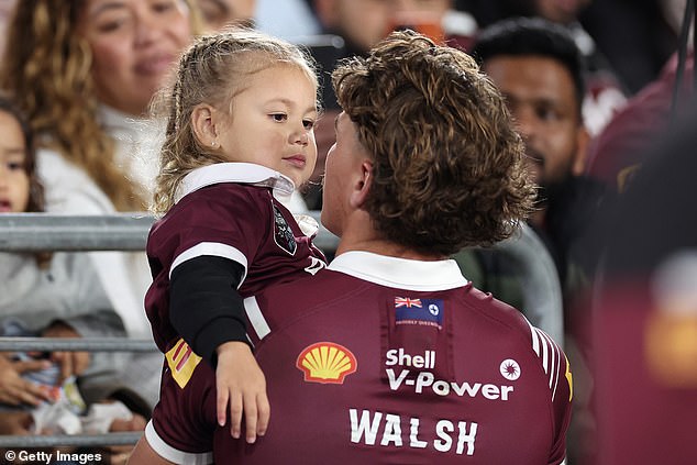 Walsh's young daughter Leila was in the crowd - and the fullback recovered well enough to find and comfort her while the match was still going (pictured)