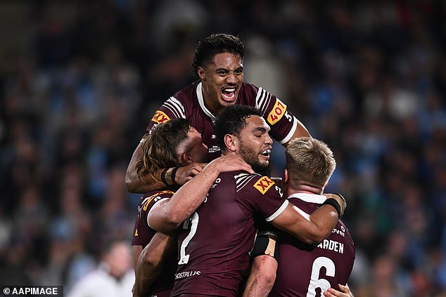 Murray Taulagi (above) leads the celebrations after the Maroons beat the Blues, who now need to win two games on the road to take back the shield