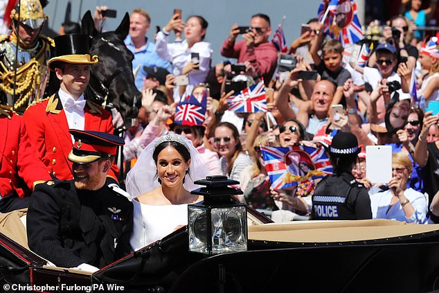 Prince Harry and Meghan Markle drive through Windsor after their wedding ceremony at St. George's Chapel at Windsor Castle