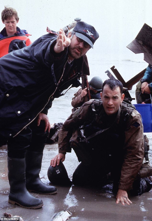 Spielberg and Hanks pictured filming the iconic opening scene in 'Saving Private Ryan' showing the Normandy landings