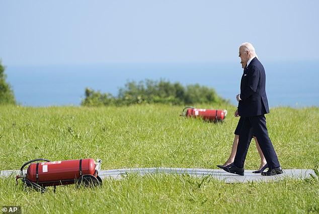 President Joe Biden and first lady Jill Biden walk off Marine One as they arrive at the Normandy American Cemetery, where they will attend ceremonies marking the 80th anniversary of D-Day