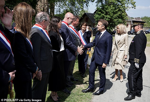 World leaders have flocked to Normandy to commemorate the 80th anniversary of D-Day.  Pictured: French President Emmanuel Macron (center) and French First Lady Brigitte Macron (second right) are welcomed by French officials upon arrival in Normandy