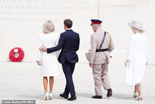 President Macron put a supportive arm around his wife as they joined King Charles and Camilla at the commemoration