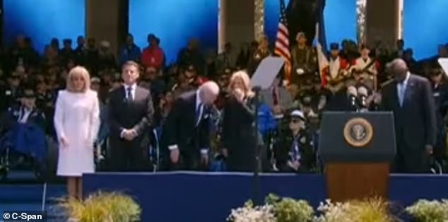 First lady Jill Biden covered her mouth and scratched under her nose as the president prepared to sit down