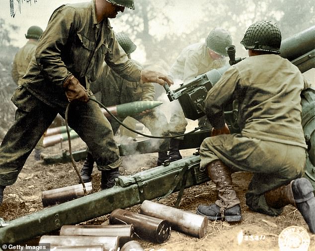 American soldiers form the 4th Infantry Division firing a 105mm HM3 Howitzer in the days after the D-Day landings in Carentan, a French town close to both the Utah and Omaha beaches