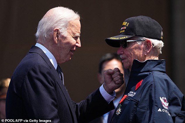 Biden greets World War II veteran Victor Chaney after he was awarded the Chevalier de la Legion d'Honneur (French Legion of Honor) during the ceremony marking the 80th anniversary of D-Day