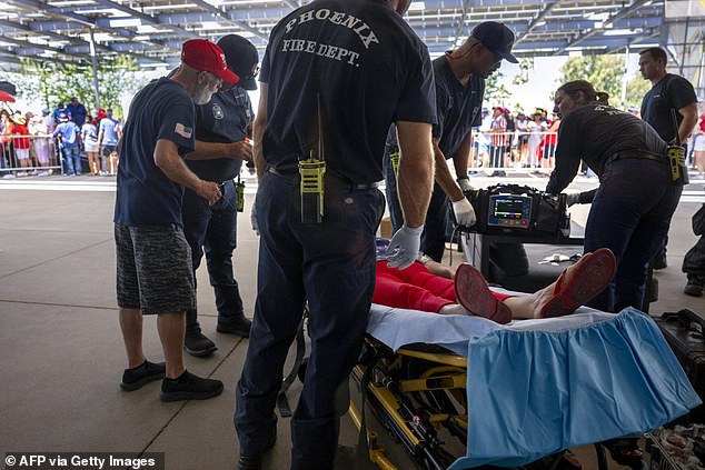 A Trump supporter is being treated for exhaustion in Phoenix on Thursday after crowds waited for hours outside the event, held at a megachurch, as temperatures reached 110 degrees