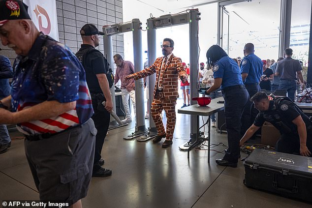 Blake Marnell, known as the 'Brick Suit' man, goes through security ahead of former President Donald Trump's appearance Thursday in Phoenix