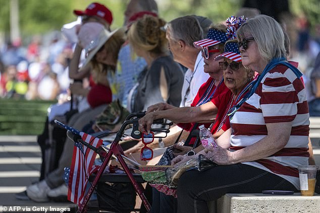 Supporters sit outside as they wait to attend former President Donald Trump's Turning Point USA event Thursday in Phoenix, held at a megachurch