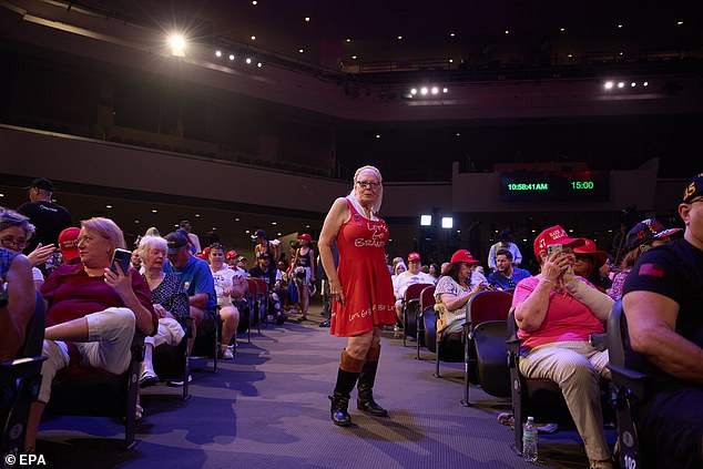 A woman stands in the aisle of Dream City Church in Phoenix on Thursday prior to former President Donald Trump's performance