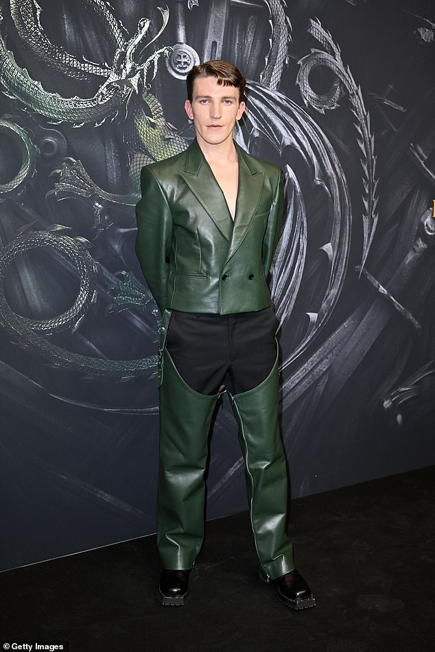 Ewan Mitchell stood out in a green leather ensemble