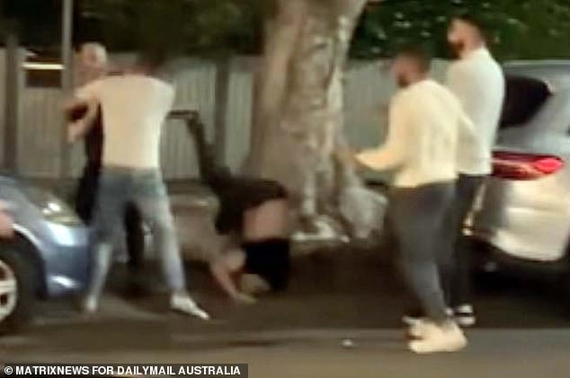 Footage of the alleged fight showed Kent (centre) hitting his head in a gutter after being thrown into a tree outside a Sydney pub.  Uzun is depicted on the left dressed in black