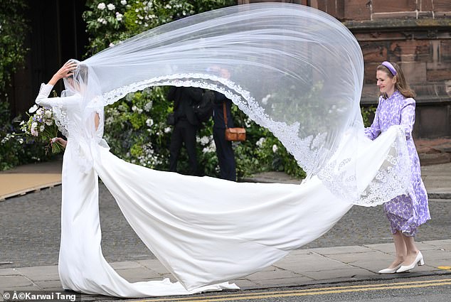 The bride's veil seemed to have a mind of its own as it flew in the wind upon Olivia's arrival