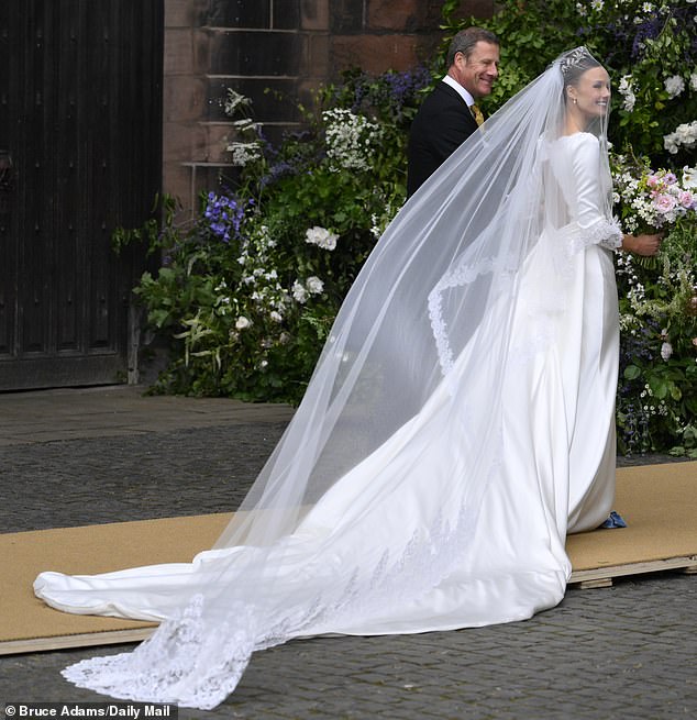 Olivia Henson in her wedding dress outside the cathedral before her wedding to Hugh Grosvenor