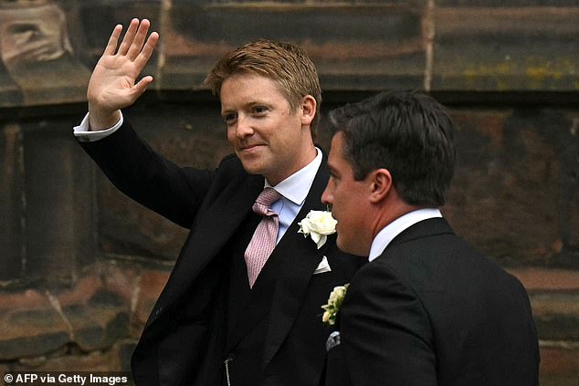 Hugh smiles and waves as he arrives at the cathedral in Cheshire to marry Olivia