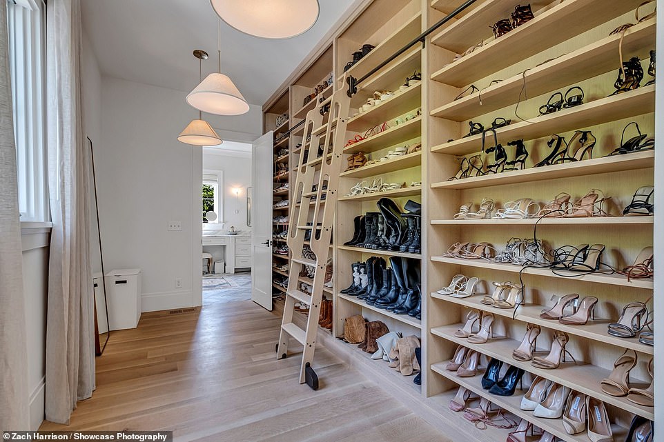 Her walk-in closet has floor-to-ceiling shelves for her shoes, as well as a ladder