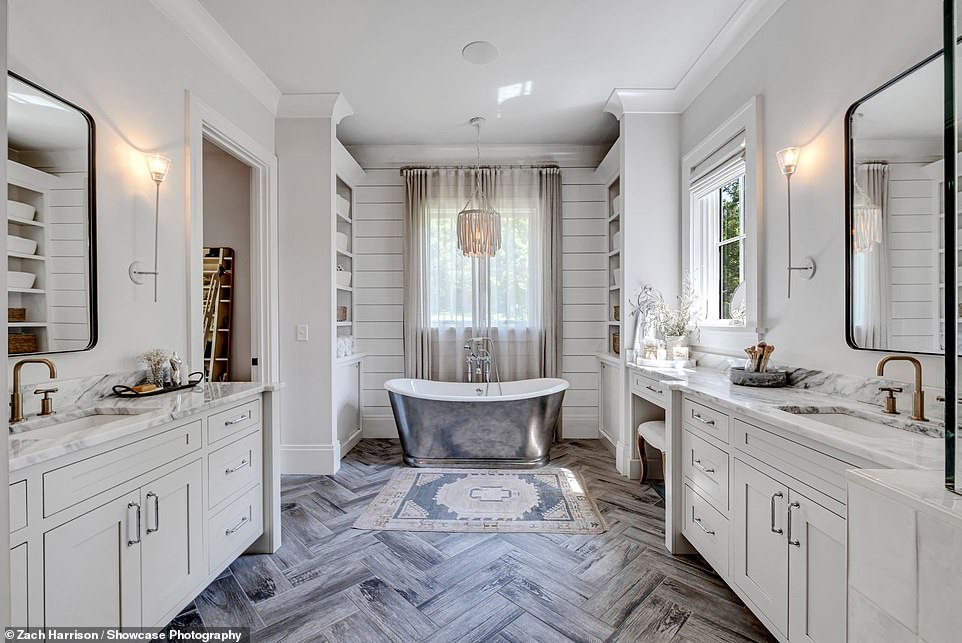 There are double sinks with beautiful floors and also a built-in vanity