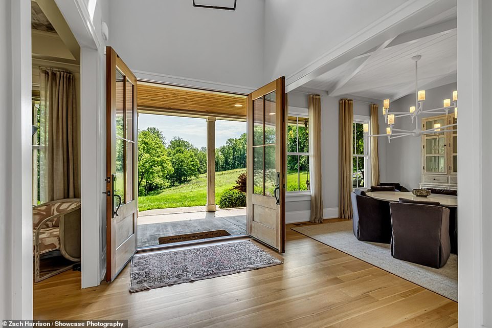 The front doors of the house are enormous and made of wood and glass