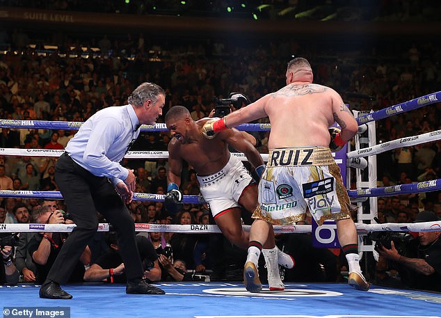 Anthony Joshua (centre) suffered the first defeat of his career in 2019 when he was toppled by Andy Ruiz Jnr (right)