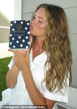 Kenedi holds a copy of the Book of Mormon